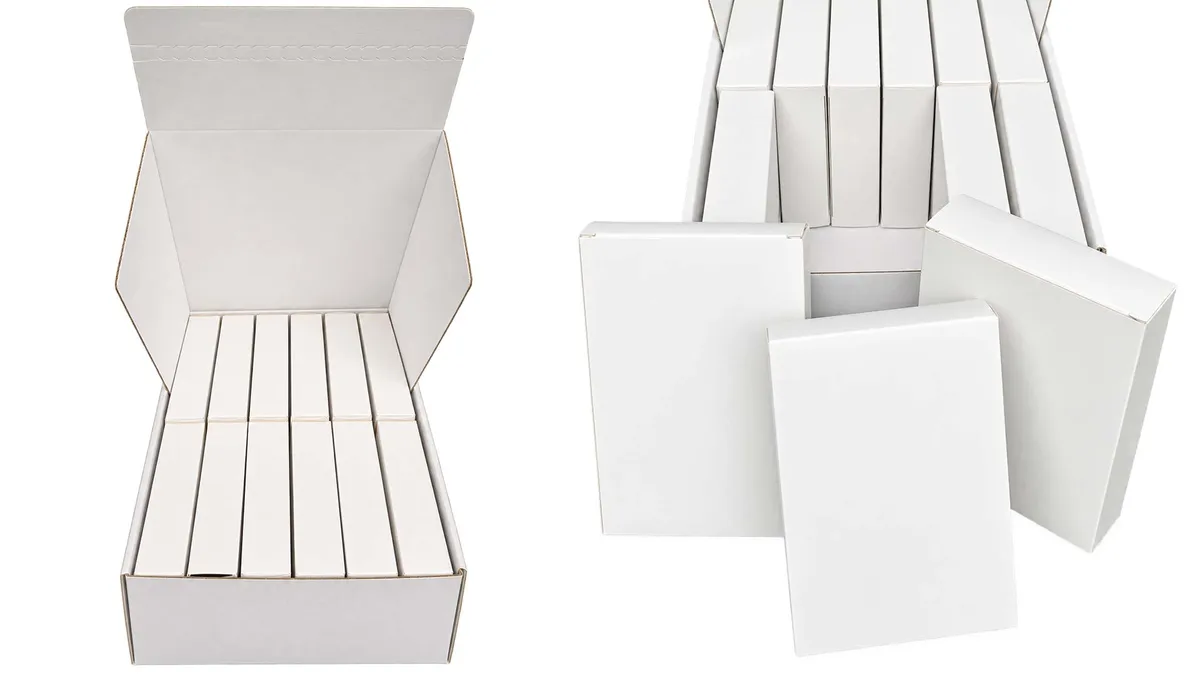 An open white outer calendar box holding twelve inner tuck boxes, beside loose inner boxes ready to be filled