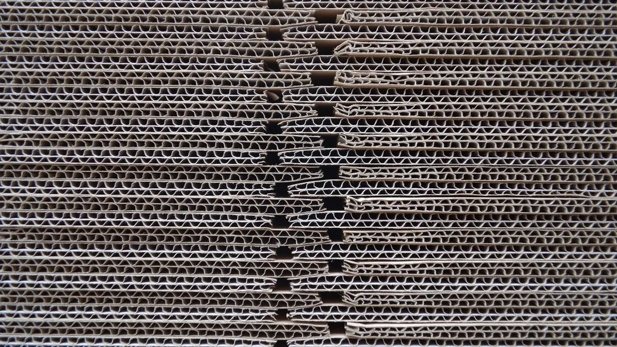 Close-up of stacked corrugated board showing the fluted layers between the liners