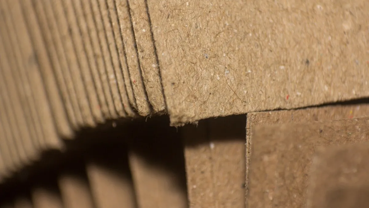 A close-up of corrugated board edges and flaps, showing the recycled fibre in the liner