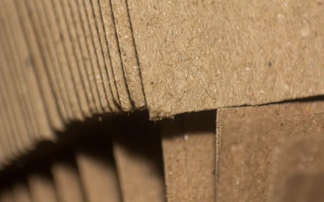 A close-up of corrugated board edges and flaps, showing the recycled fibre in the liner