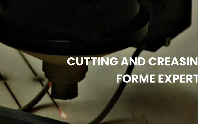 A laser head cutting the rule slots into a forme board at a die shop