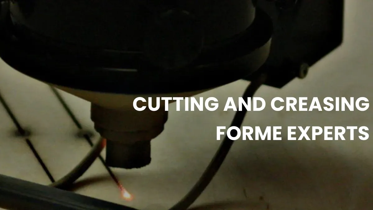 A laser head cutting the rule slots into a forme board at a die shop