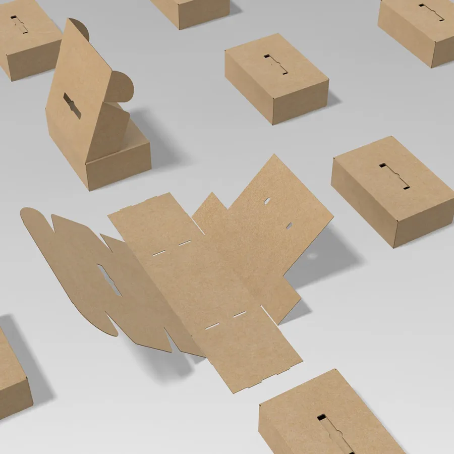 A flat die-cut blank laid out among erected mailer boxes, showing the cut and crease pattern