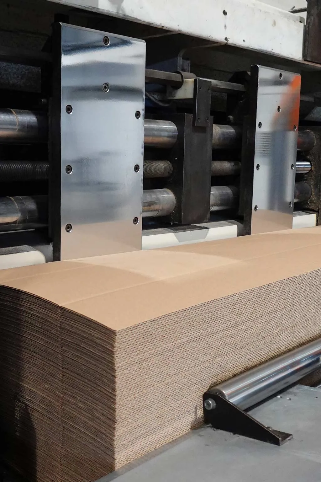 Corrugated sheets entering the feed of the line, where print is applied