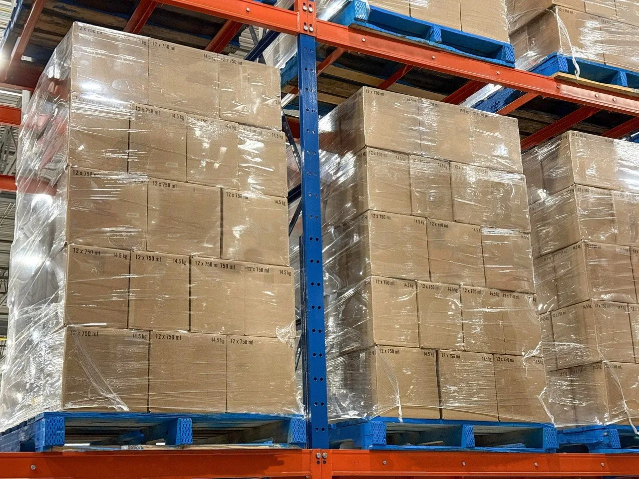Pallets of corrugated cases stacked in a warehouse