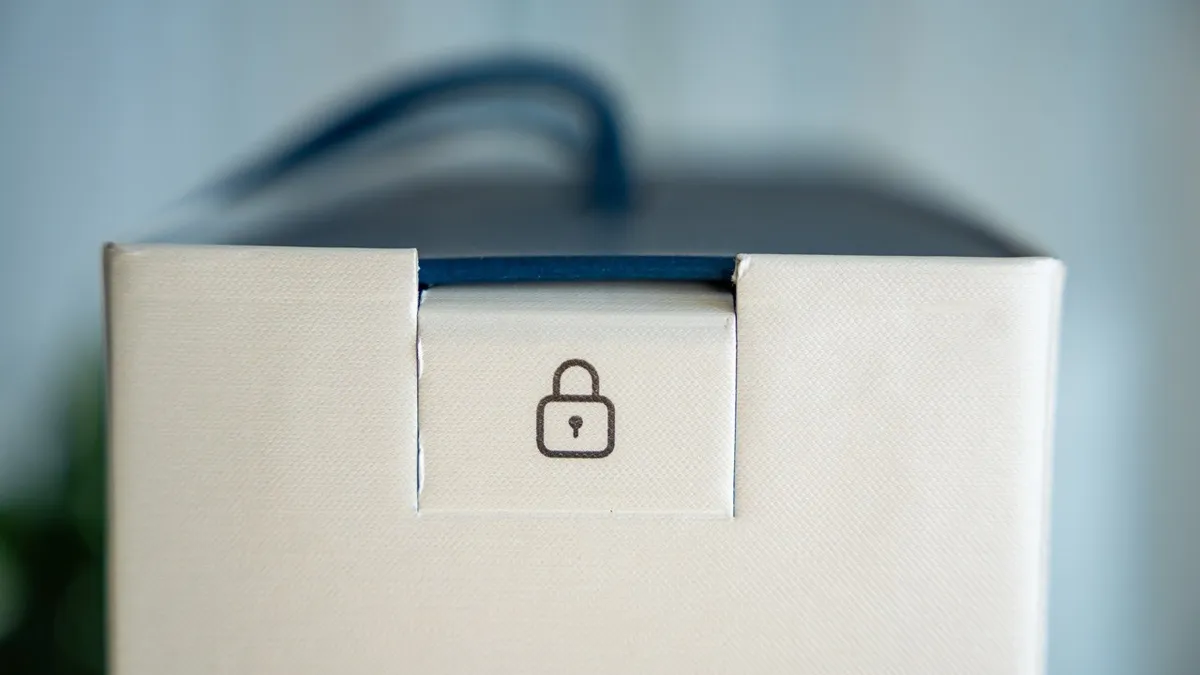A sealed tab across the lid of a carton, printed with a padlock mark