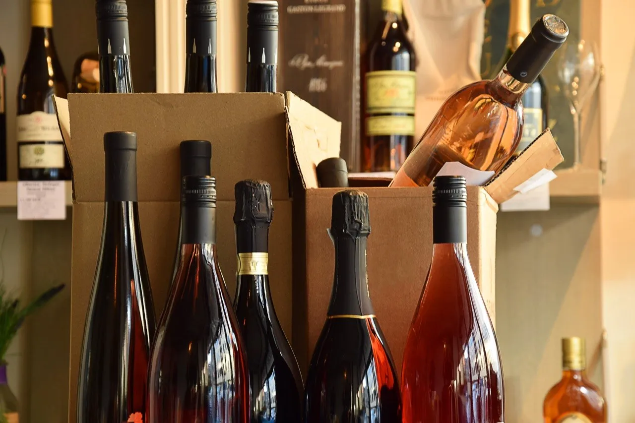 Wine bottles standing in front of open corrugated shipping cases