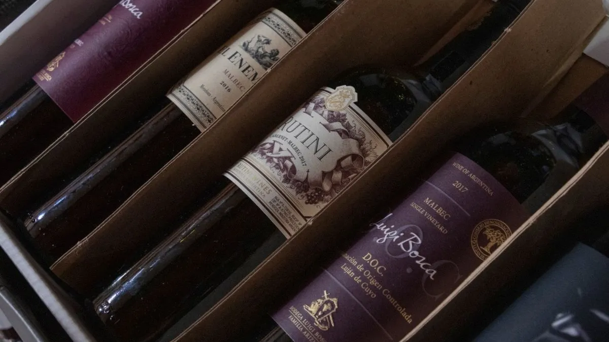 Wine bottles lying in the corrugated divider slots of a shipping case